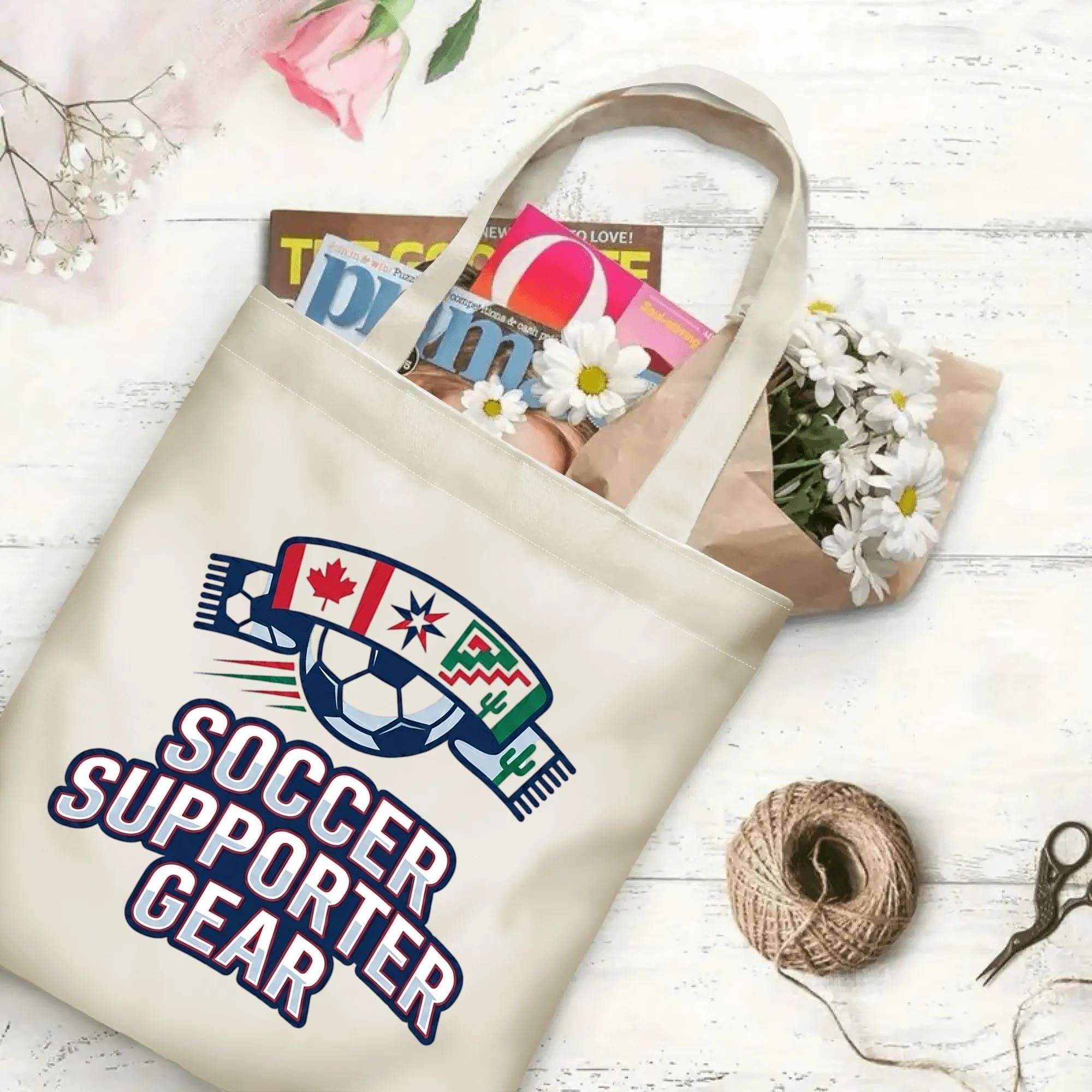 Retro varsity scarf wrapped soccer graphic canvas tote bag laid flat with magazines and daisies, reusable gameday sport fan daily shopping bag