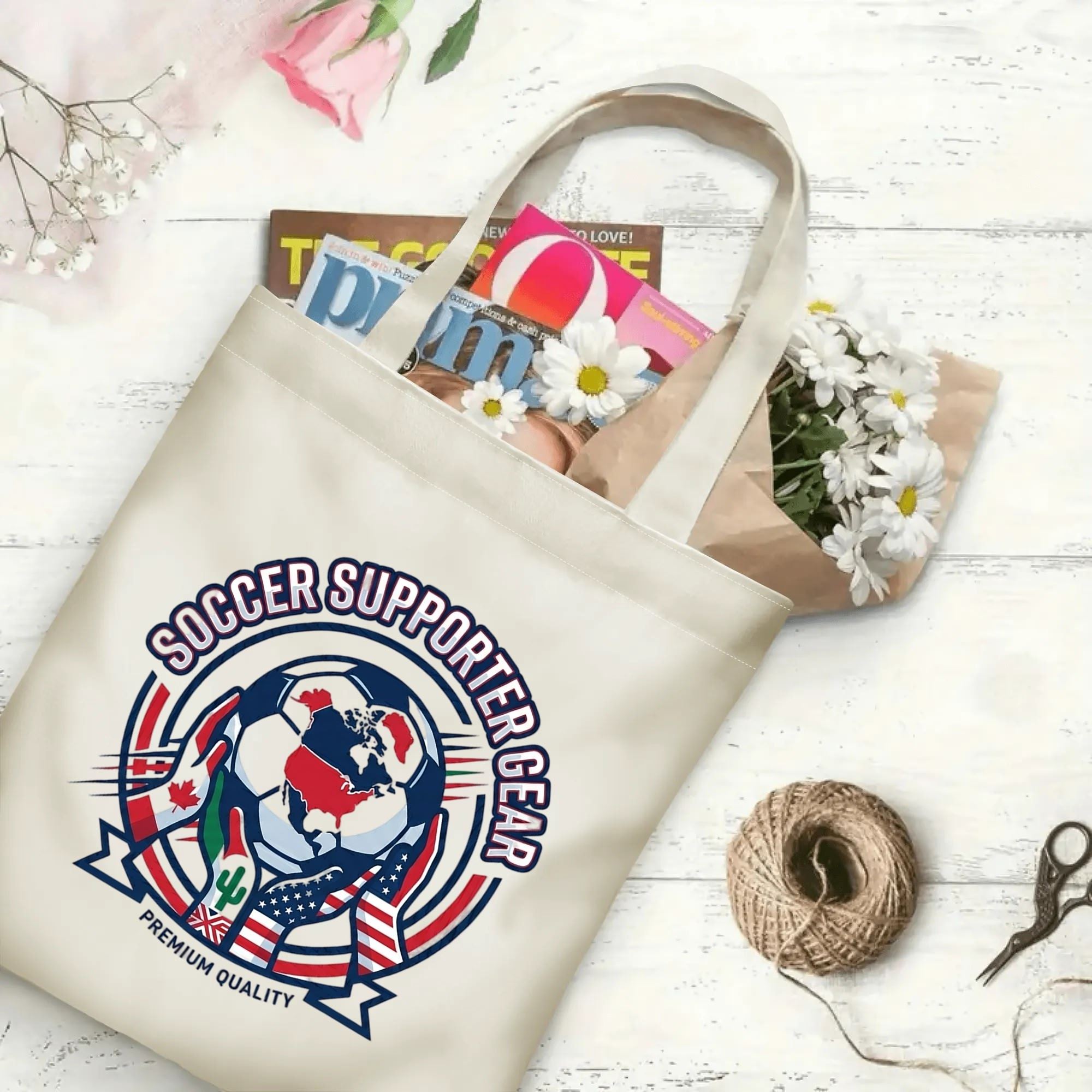 Vintage varsity flag hands soccer globe graphic canvas tote bag laid flat with magazines and daisies, reusable classic sport fan daily shopping bag