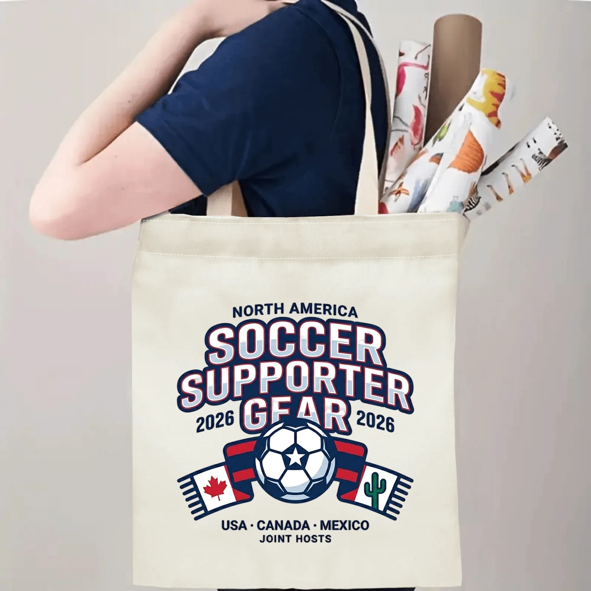 Person slinging 2026 World Cup USA Canada Mexico soccer supporter emblem polyester canvas tote bag over shoulder, large capacity athletic football supporter carry bag for stadium outings