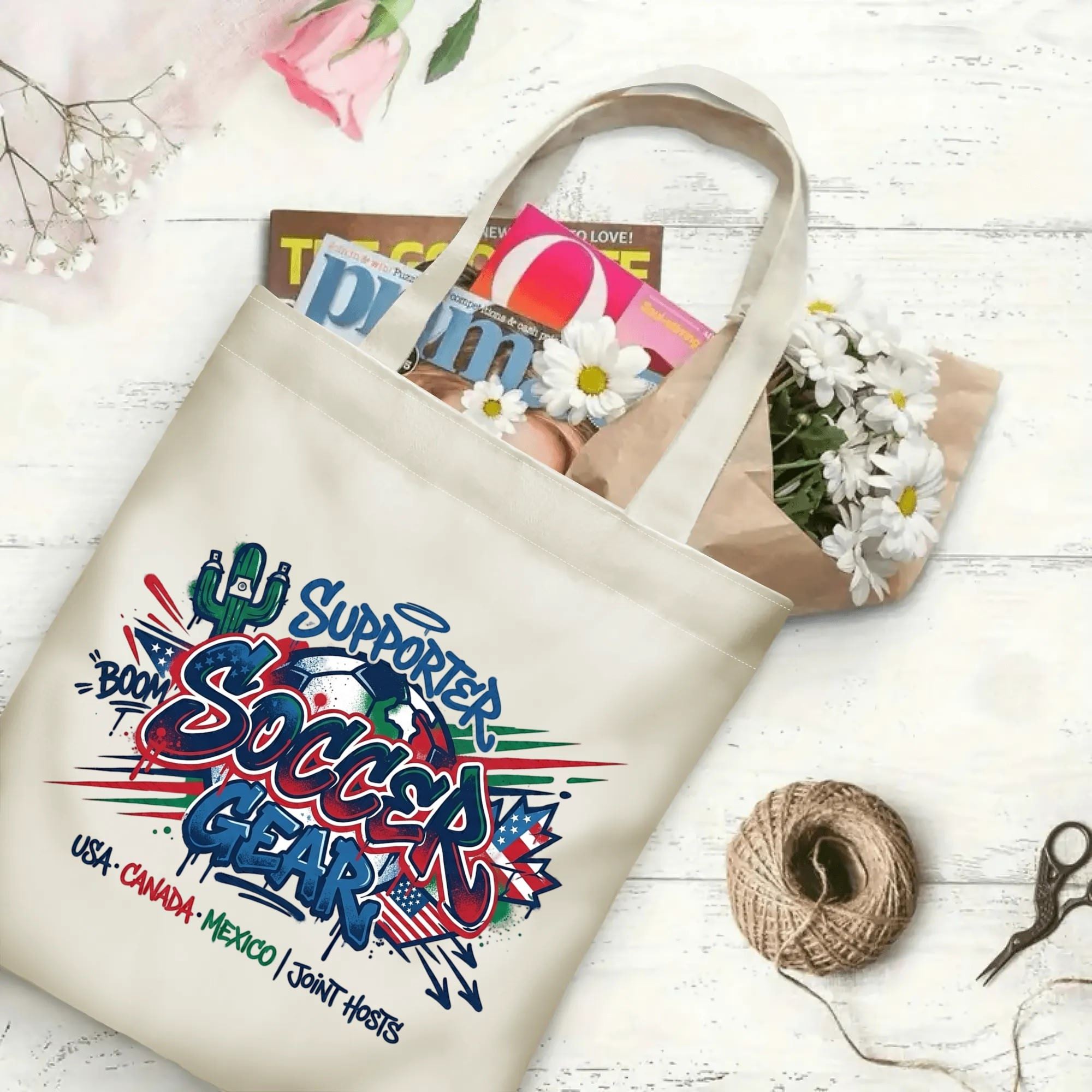 Color splash cactus flag graffiti soccer graphic canvas tote bag laid flat with magazines and daisies, reusable urban gameday sport fan daily shopping bag