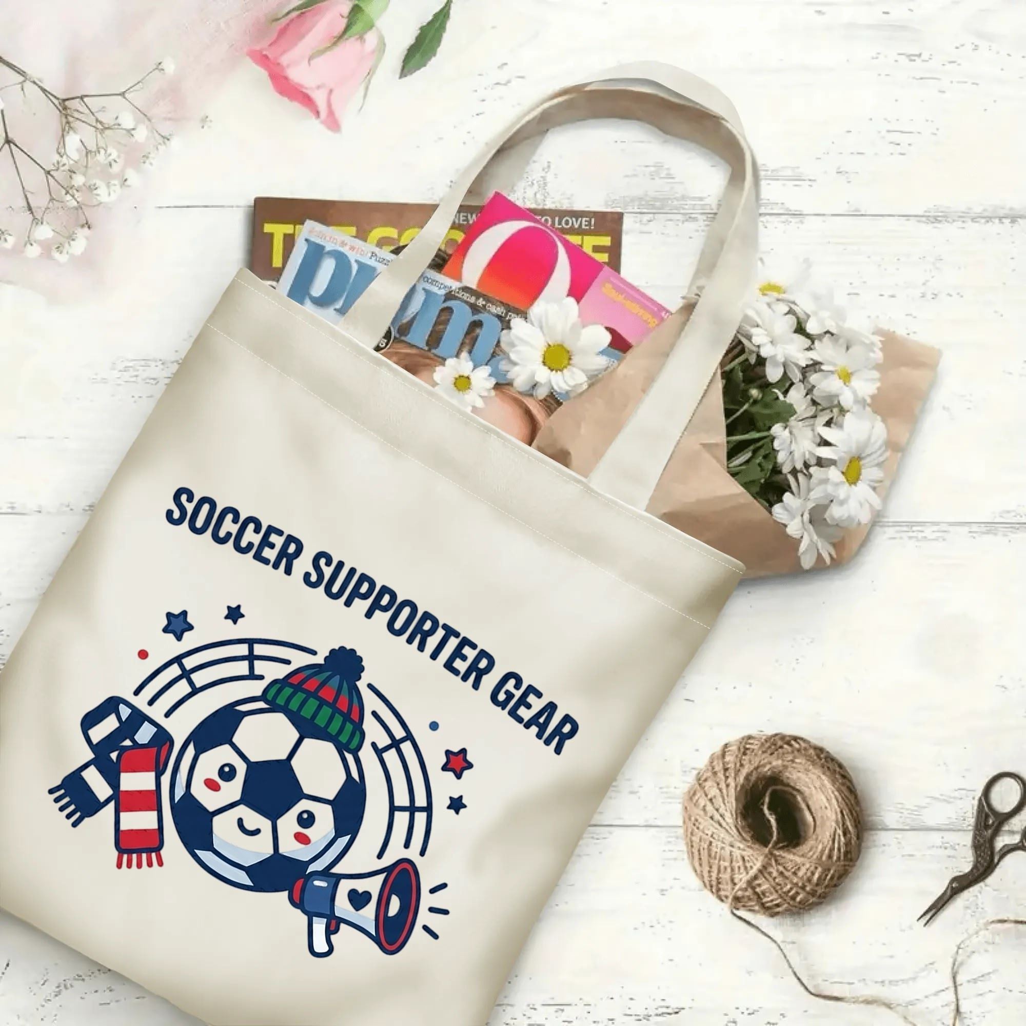 Minimal megaphone scarf soccer cartoon graphic canvas tote bag laid flat with magazines and daisies, reusable casual sport fan daily shopping bag