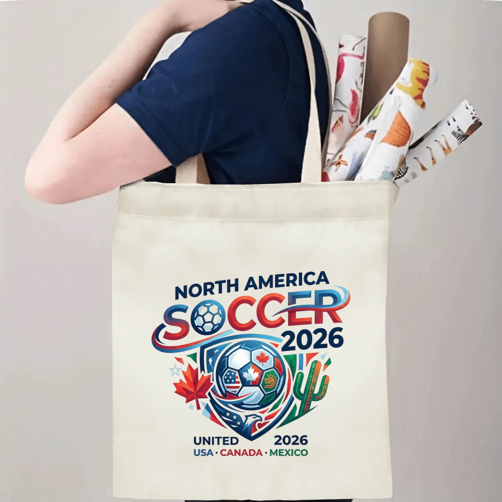 Person slinging sleek North America Soccer 2026 crest canvas tote bag over shoulder, large capacity modern patriotic football fan carry bag for stadium trips