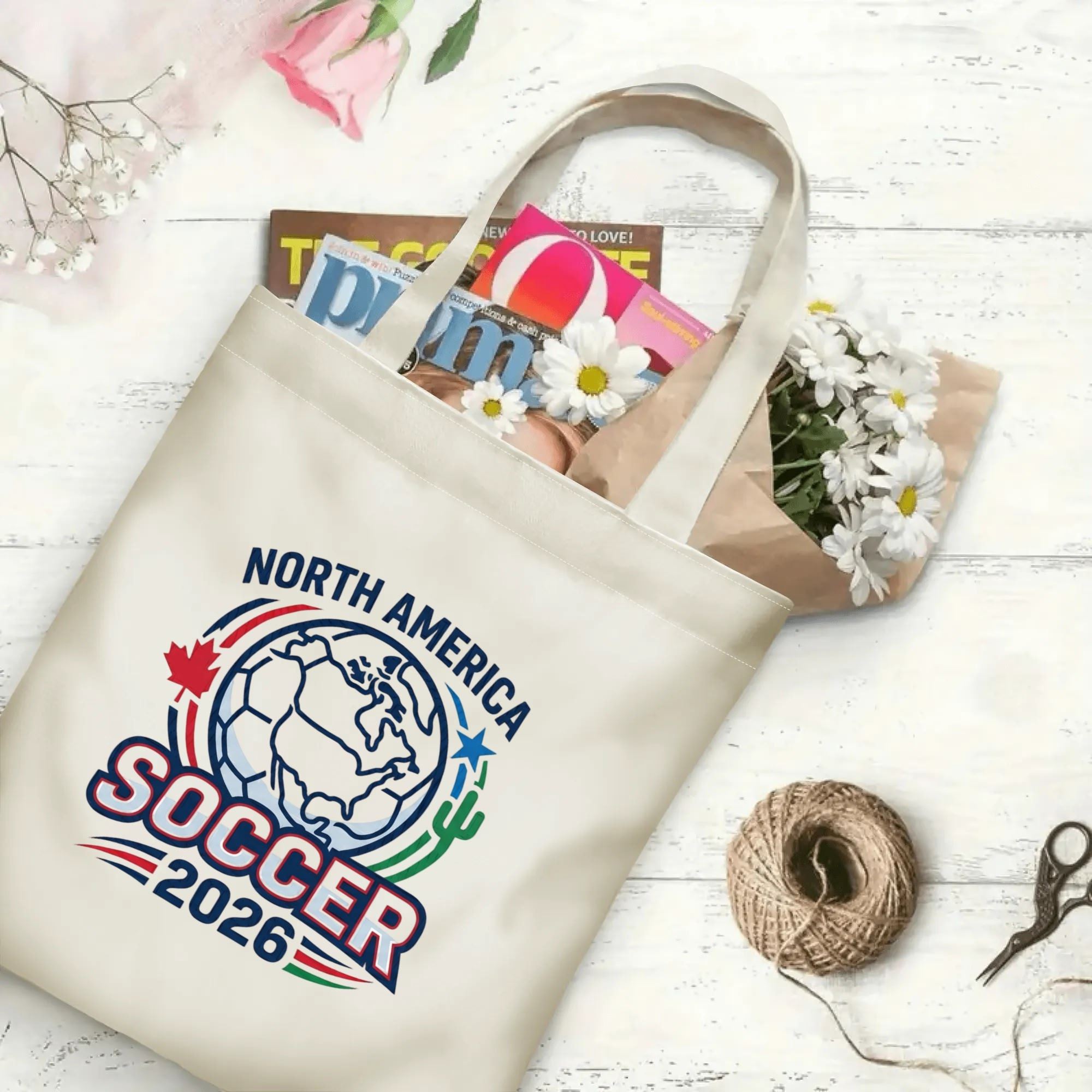 Retro varsity North America map soccer graphic canvas tote bag laid flat with magazines and daisies, reusable subtle sport fan daily shopping bag