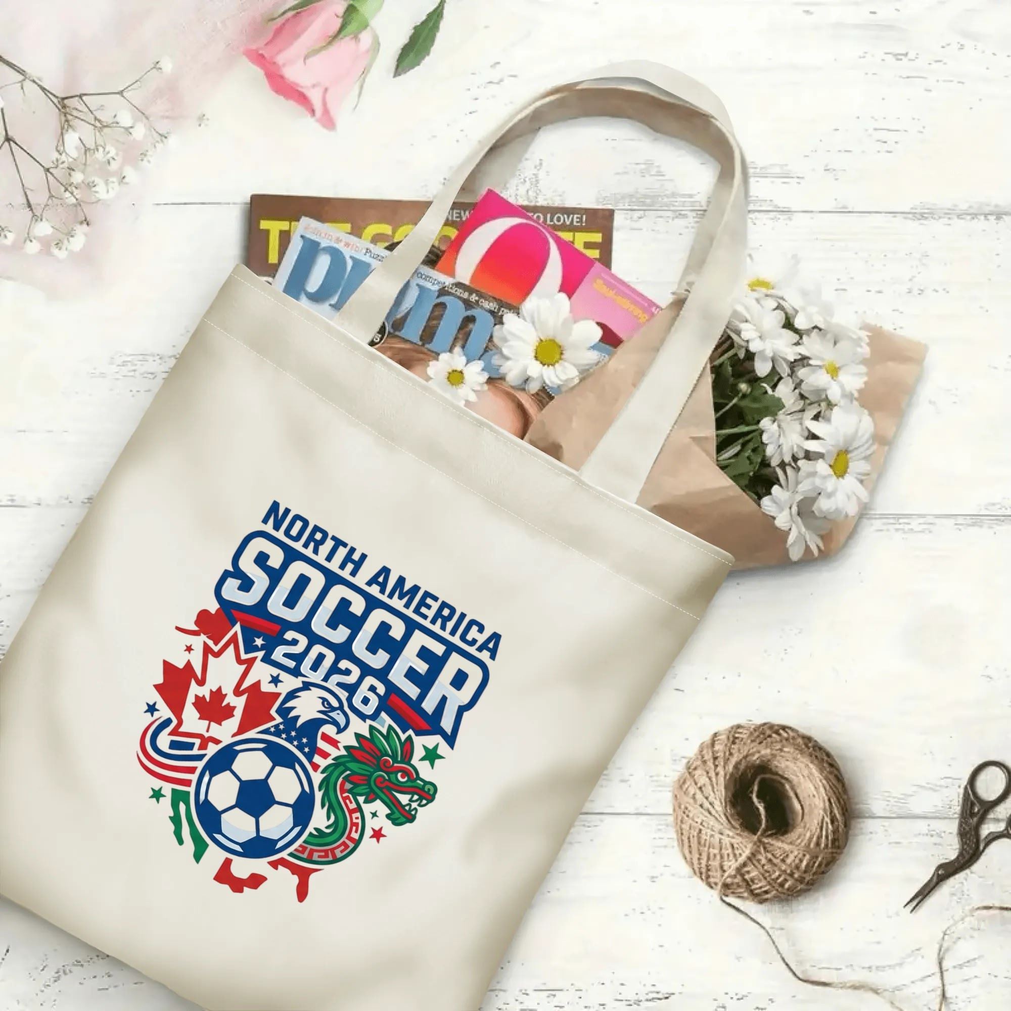 Bold varsity mascot soccer graphic canvas tote bag laid flat with magazines and daisies, reusable sport fan daily shopping bag