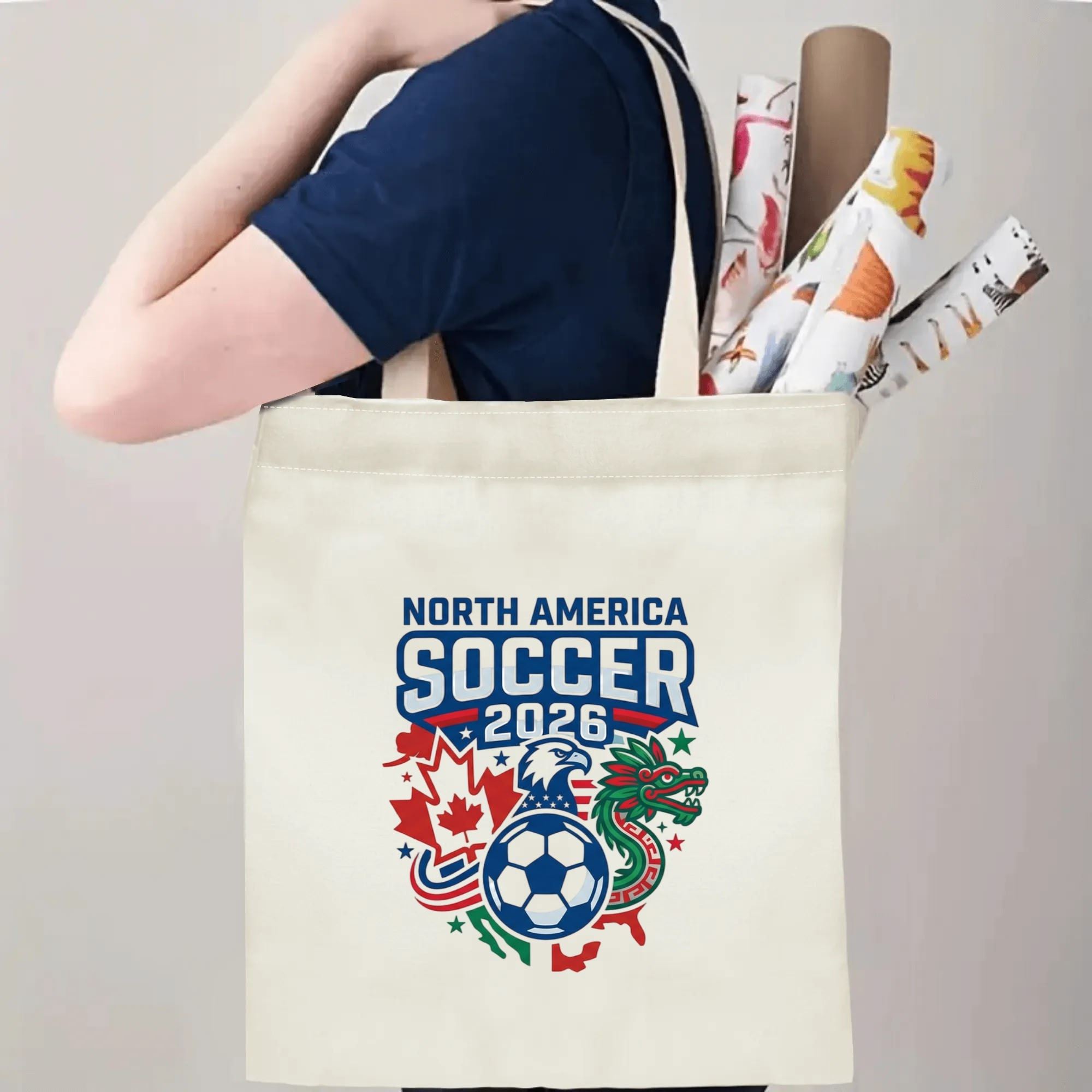 Person slinging 2026 USA Canada Mexico eagle dragon soccer tote bag over shoulder, large capacity athletic football fan carry bag for stadium trips