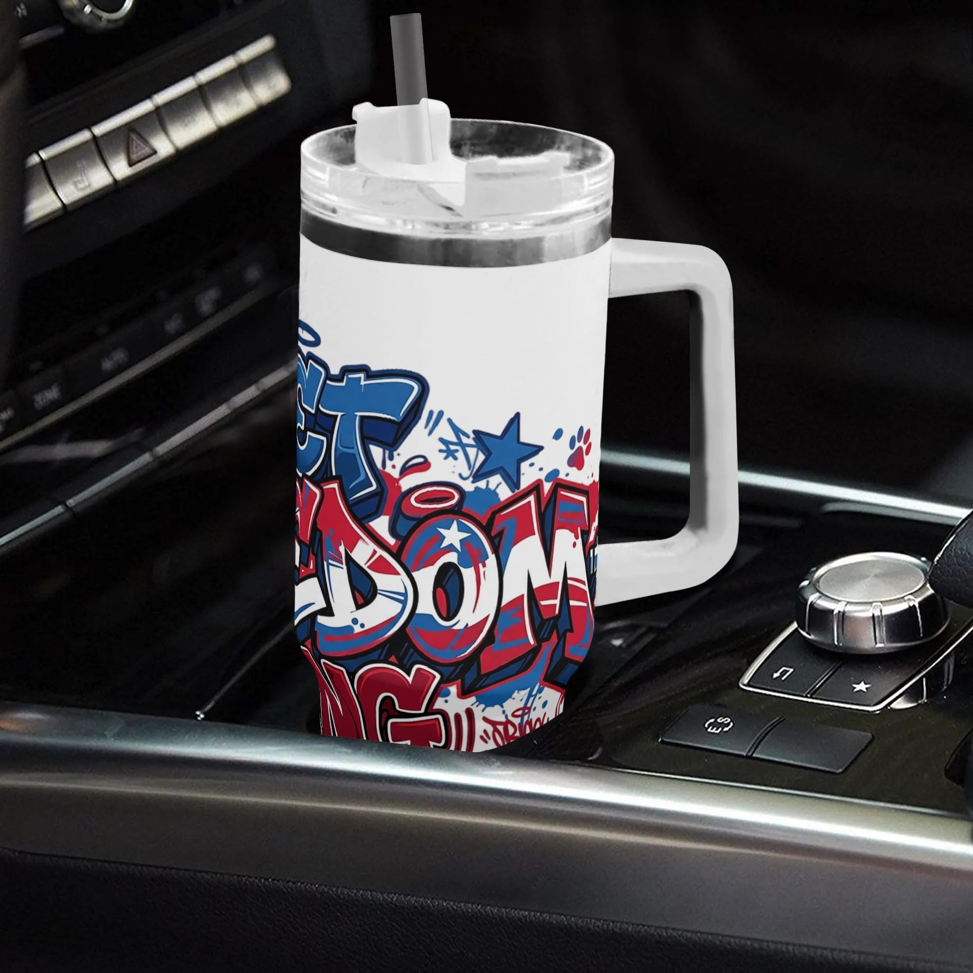 40oz handled stainless steel tumbler with full-wrap red-blue USA flag graffiti "Let Freedom Ring" star paw print print, patriotic insulated travel cup placed in car cup holder
