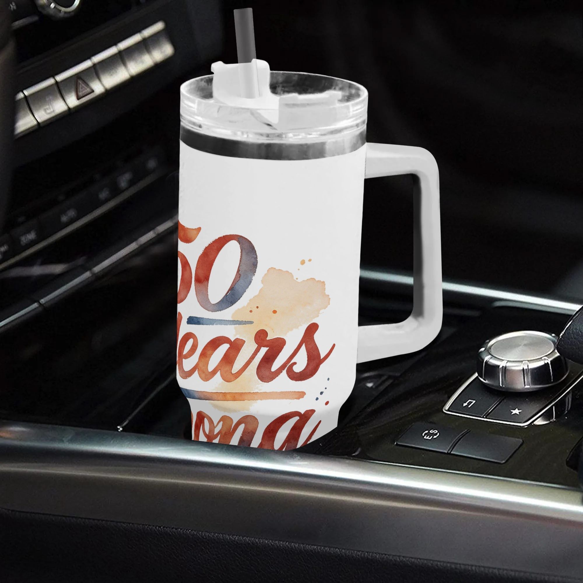 Lifestyle shot of the “250 Years Strong” watercolor tumbler in a car cup holder, showing the patriotic print