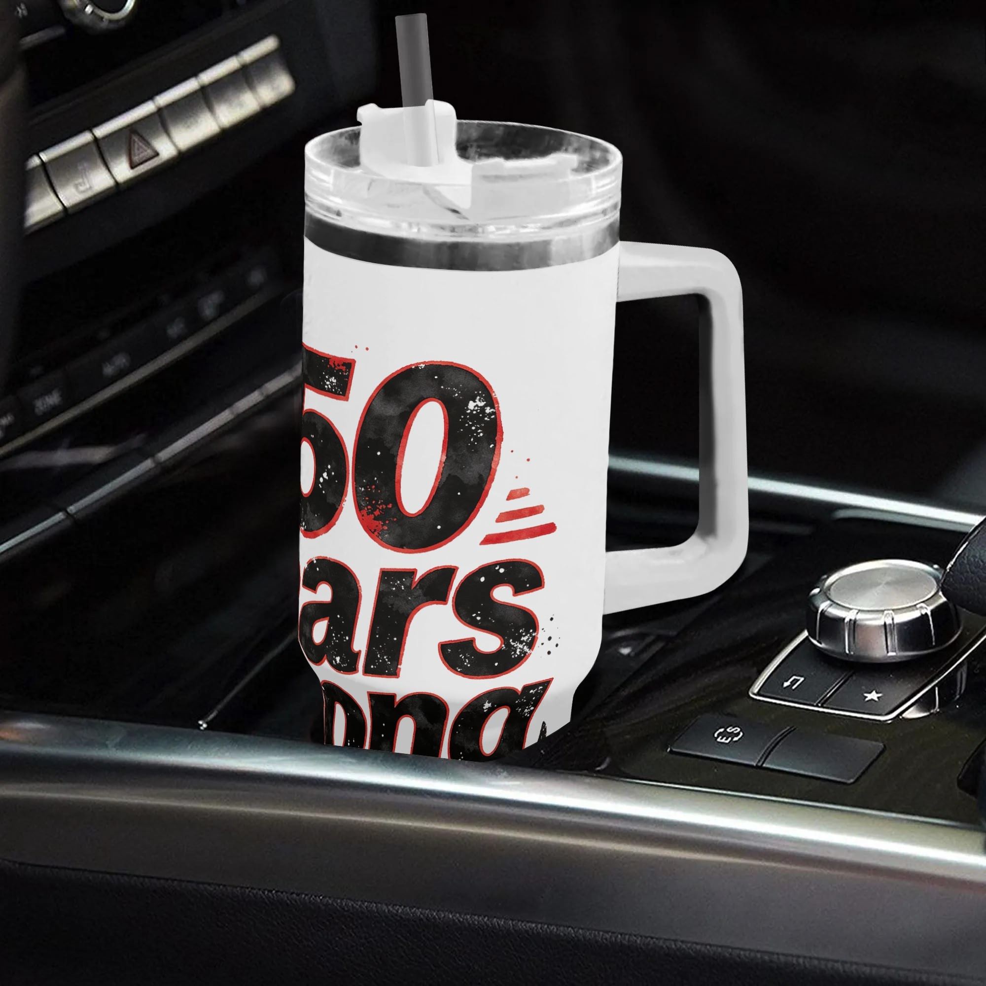 Lifestyle shot of the “250 Years Strong” distressed tumbler in a car cup holder, showing the black and red patriotic print