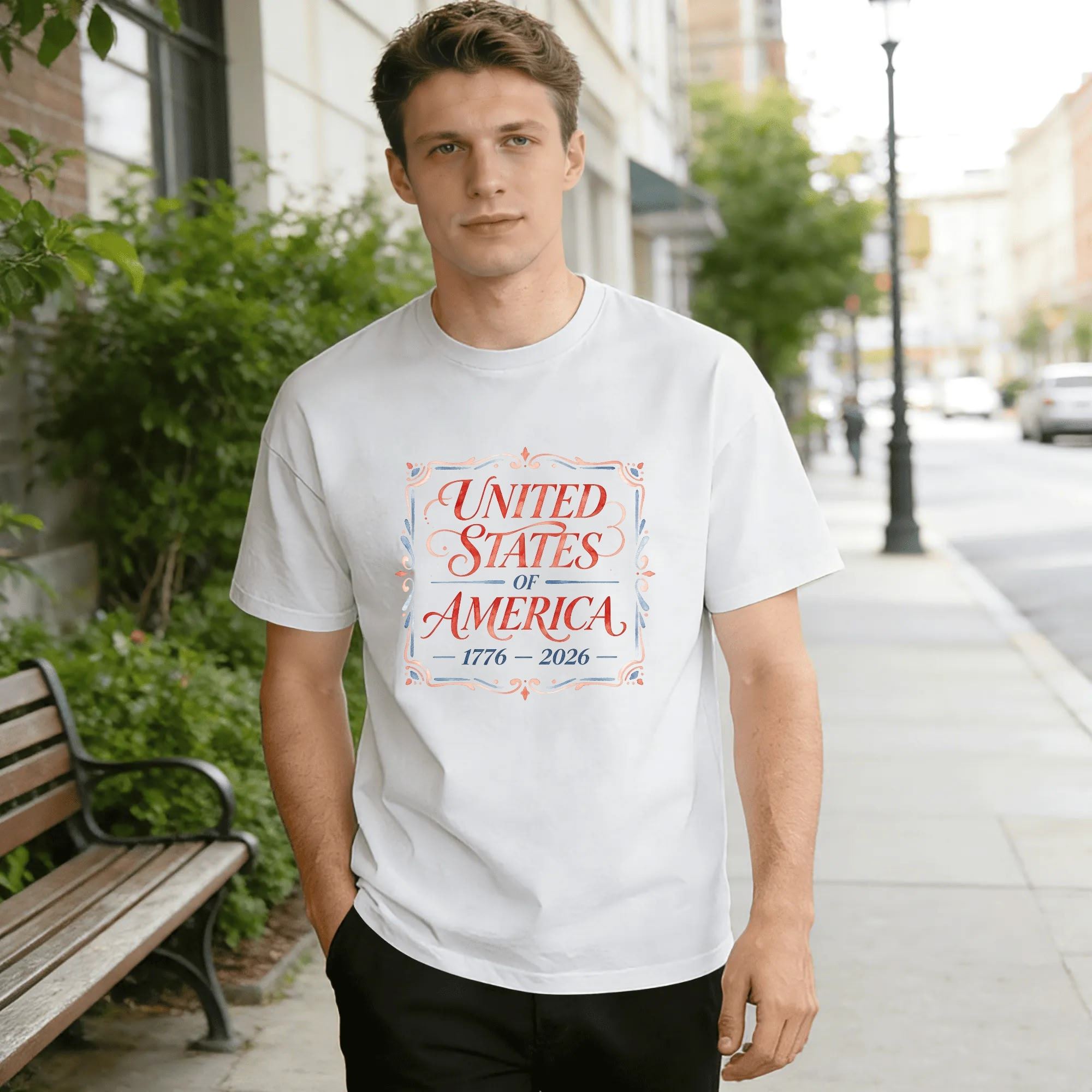 Lifestyle shot of the white “United States of America 1776-2026” watercolor T-shirt worn outdoors