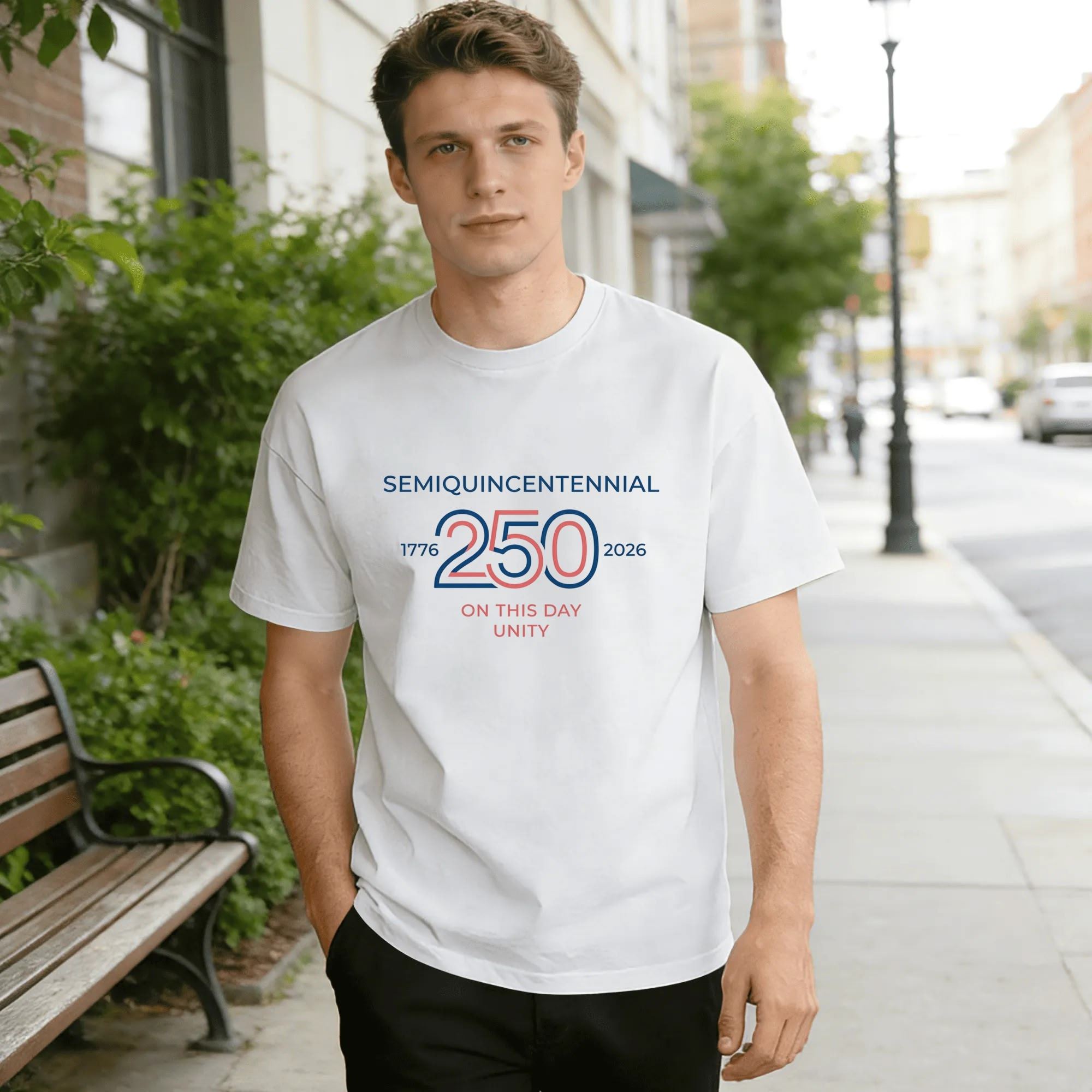 Lifestyle shot of a man wearing the white minimalist "Semiquincentennial 250" T-shirt on a city street.
