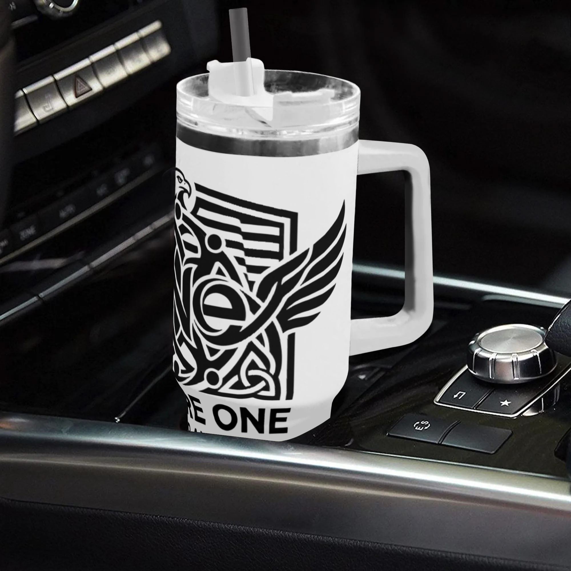 White 40oz handle tumbler with We Are One Forever America eagle patriotic print placed in car gear shift holder, USA 250th travel mug