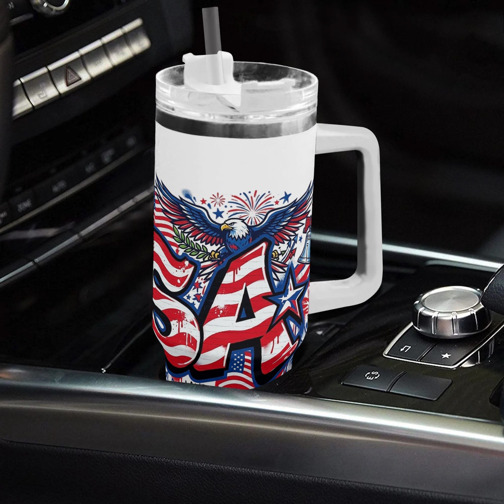 Car interior lifestyle photo: White 40oz insulated tumbler with handle placed on car gear console, full wrap street graffiti USA bald eagle liberty bell print, patriotic large capacity travel water cup