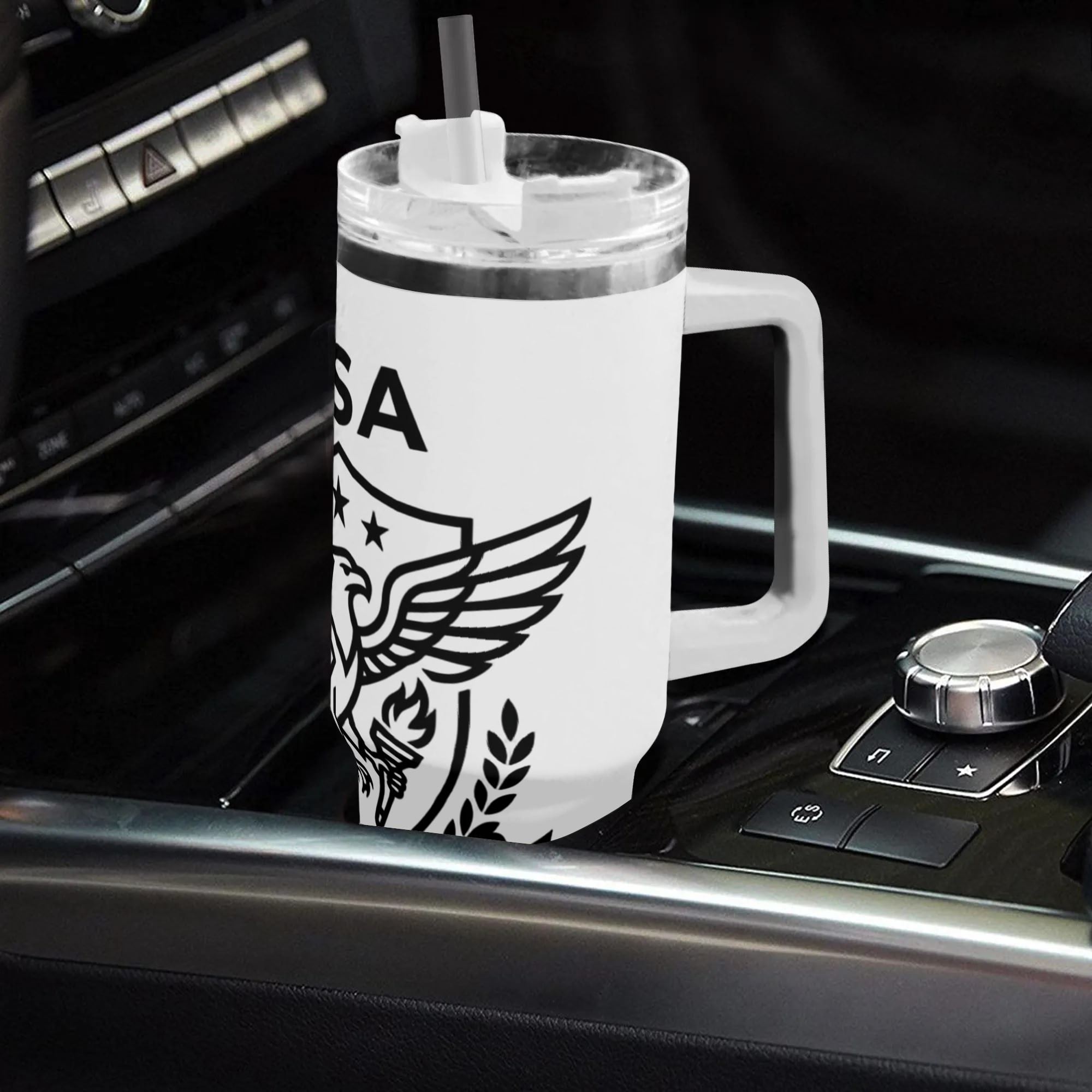 40oz USA 250th semiquincentennial patriotic tumbler with handle placed in car center console, minimalist black line bald eagle star shield "Born Of Liberty USA" print insulated stainless steel travel mug