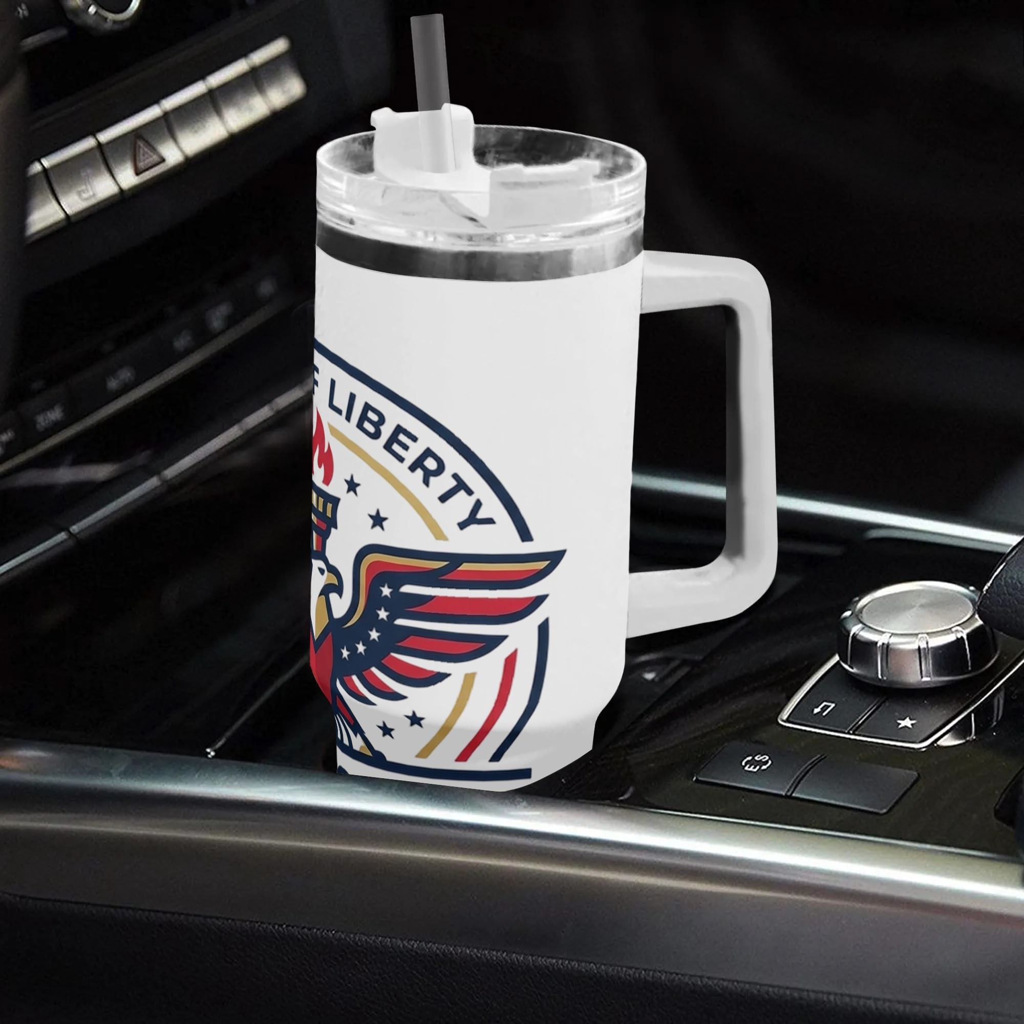 40oz USA 250th semiquincentennial patriotic tumbler with handle placed in car center console, Born Of Liberty bald eagle liberty torch circle emblem print insulated stainless steel travel mug