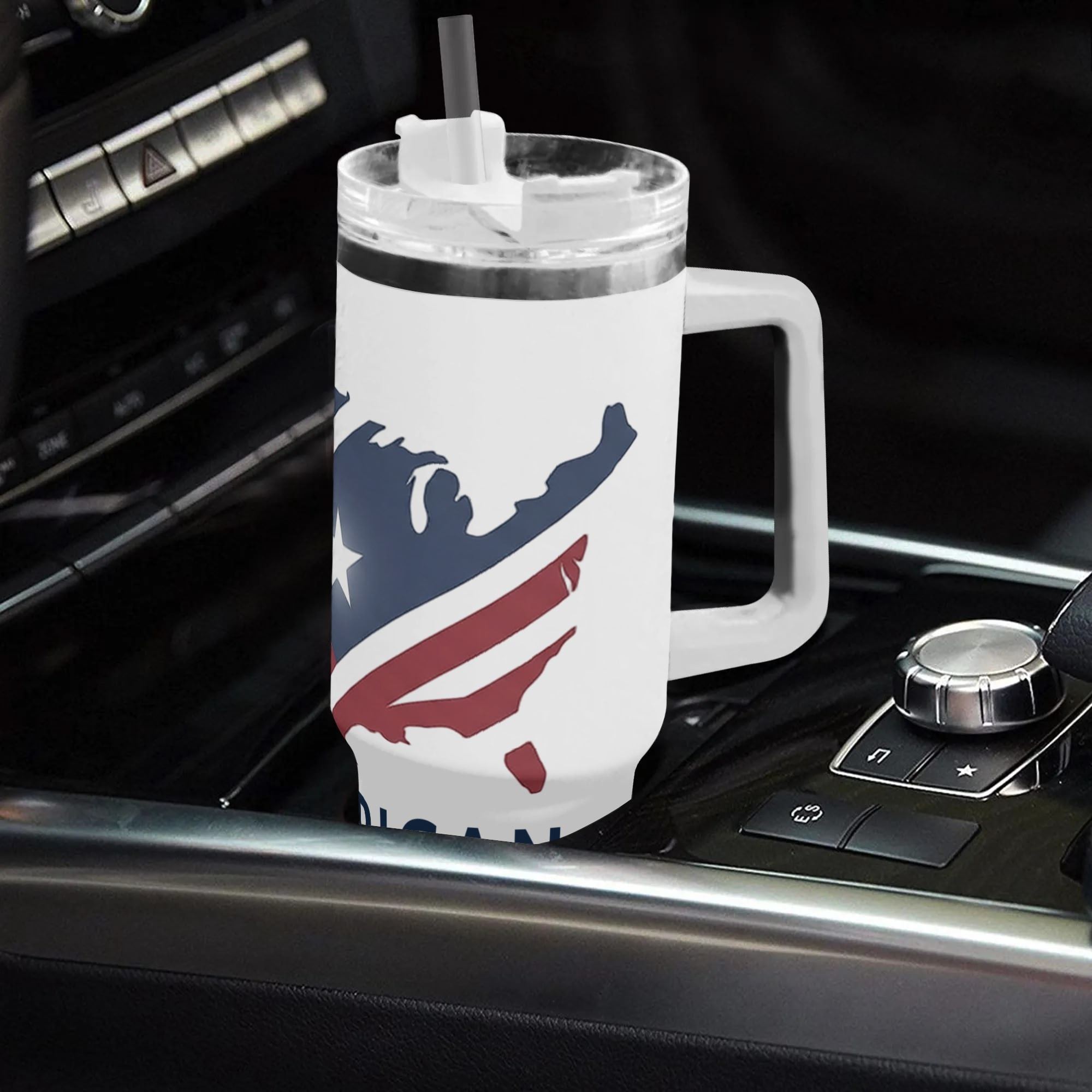 40oz USA 250th semiquincentennial tumbler with handle resting in car gear console, minimalist US continent map star stripe flag "America Story" full wrap insulated stainless steel travel mug