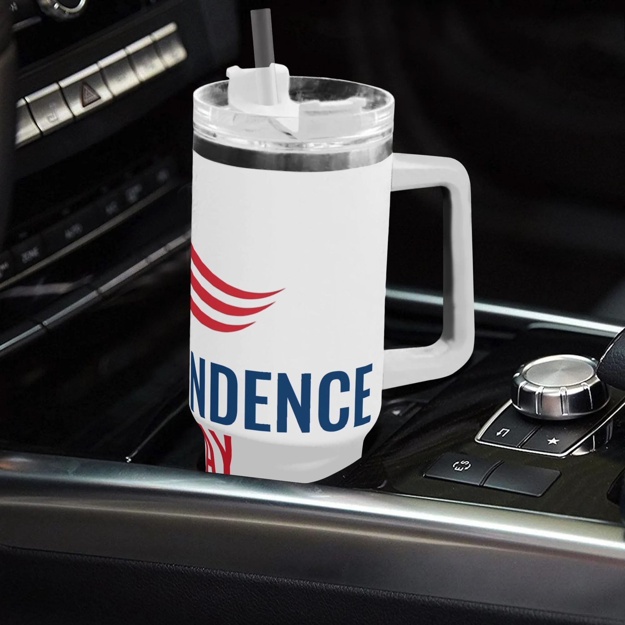 White 40oz patriotic Independence Day stainless steel tumbler with handle placed in car center console, USA star red stripes print insulated travel mug for 4th of July