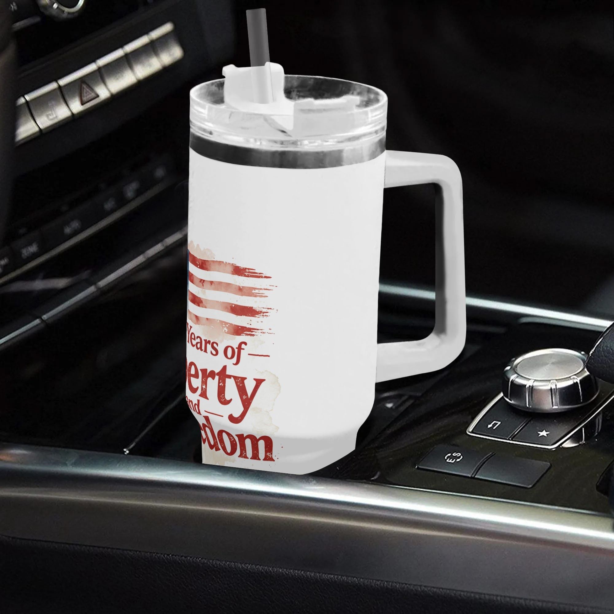 40oz USA 250th semiquincentennial tumbler with handle placed in car gear console, vintage faded watercolor US flag "250 Years of Liberty and Freedom" full wrap insulated stainless steel travel mug