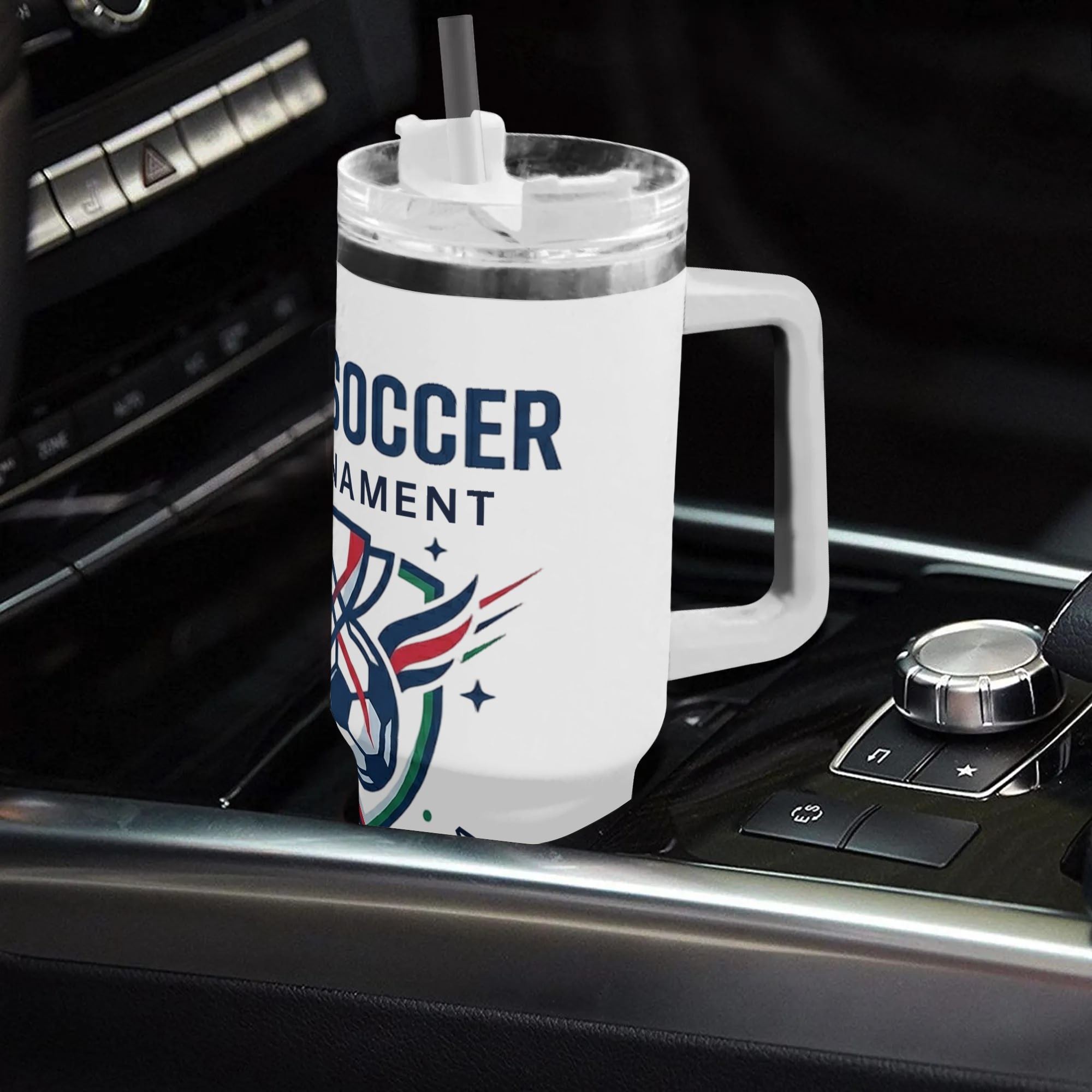 40oz 2026 World Cup soccer shield emblem handled tumbler placed in car gear shift console, minimal winged trophy USA Canada Mexico print insulated stainless steel travel mug