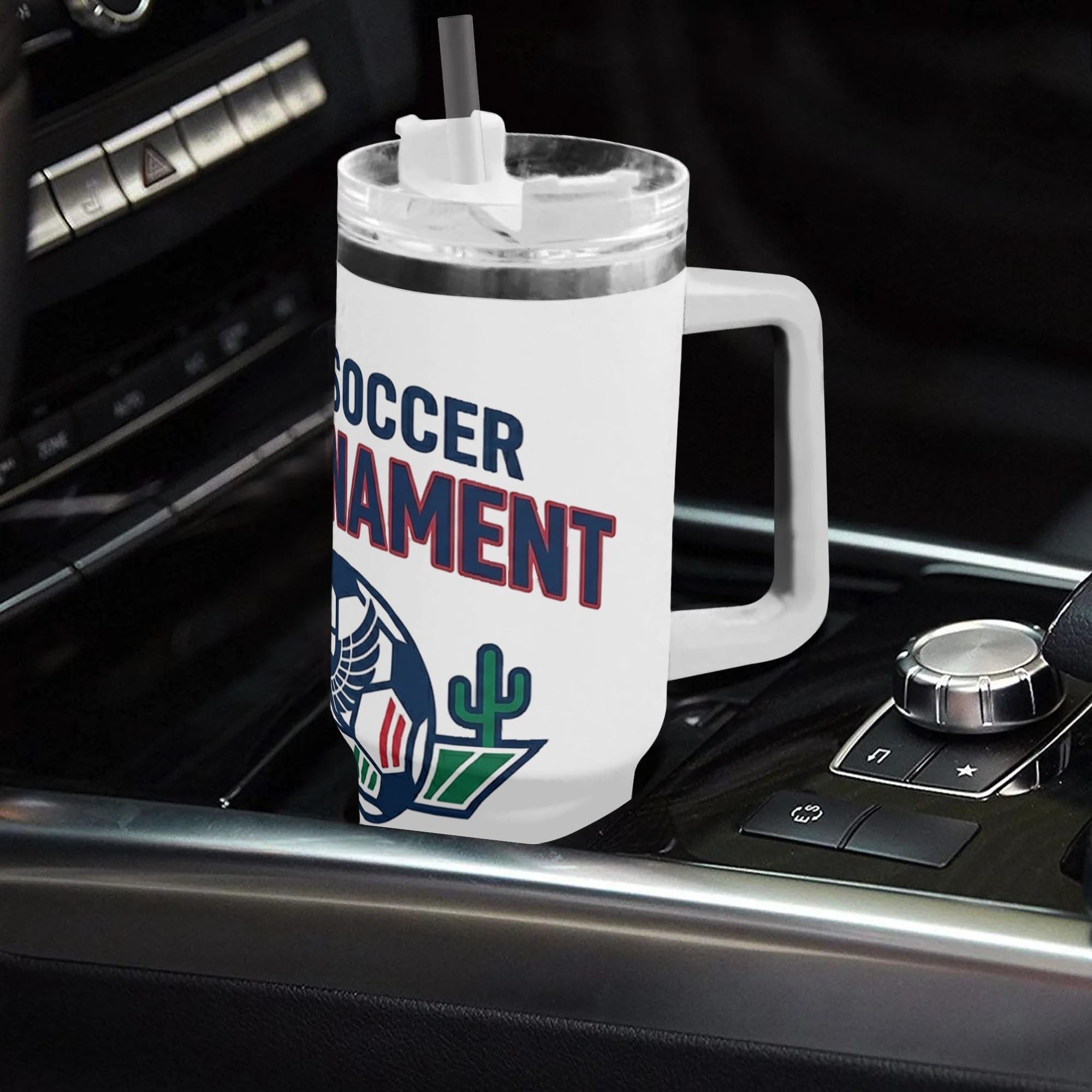 White 40oz handled insulated tumbler with vintage eagle crest soccer maple cactus print placed in car gear shift console, minimalist 2026 World Cup patriotic stainless steel travel mug for driving soccer fans