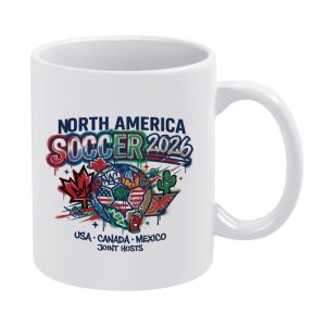 White 11oz ceramic mug with vibrant graffiti-style "North America Soccer 2026" print, featuring USA/Canada/Mexico host symbols, a dripping soccer ball, and street-art details.