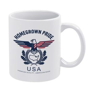 White 11oz ceramic mug with a patriotic "HOMEGROWN PRIDE" print, featuring a stylized American flag eagle, USA map, and laurel wreaths, with "PREMIUM QUALITY, AMERICAN MADE" text.