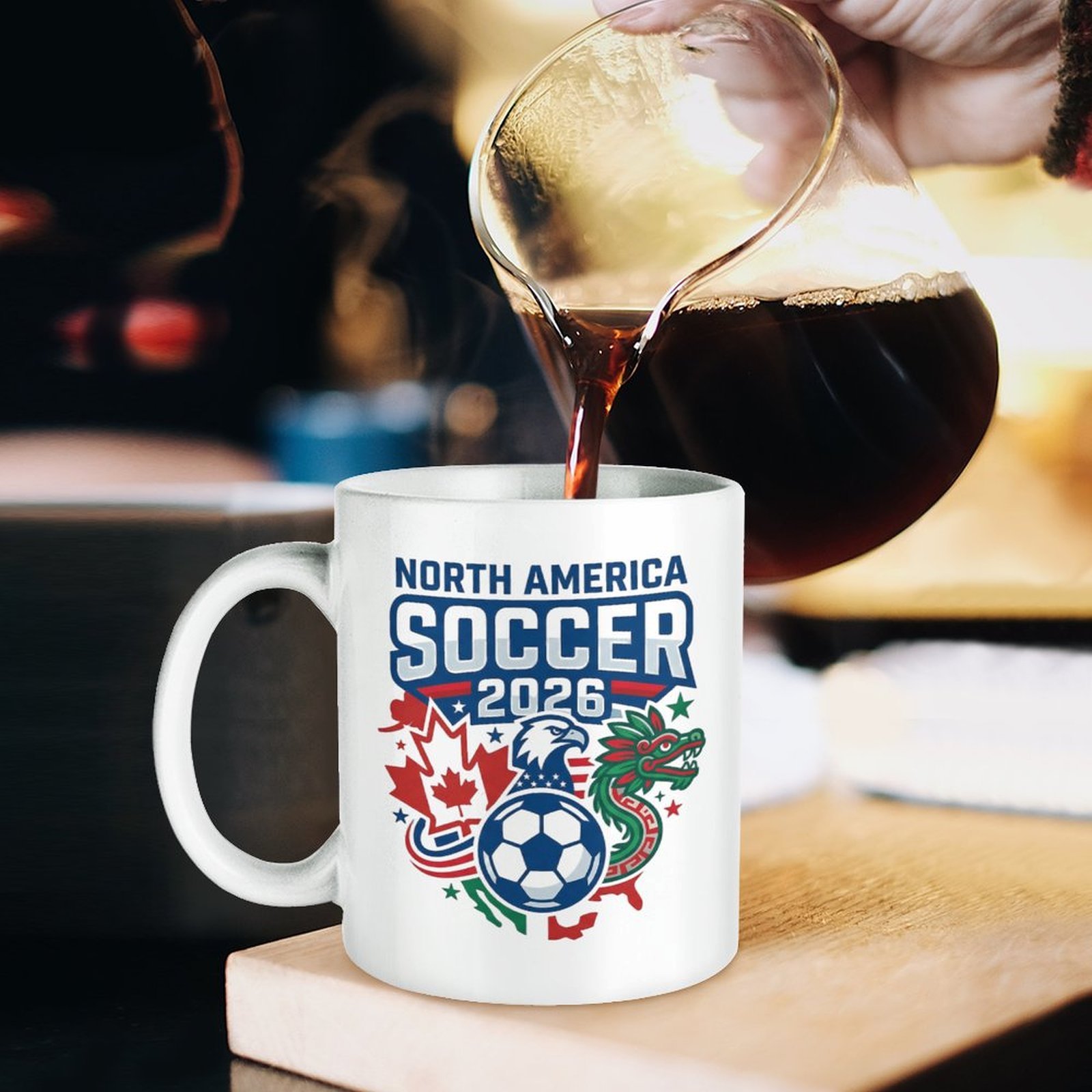 Lifestyle shot of the tournament-themed mug being filled with coffee, showing the full "North America Soccer 2026" graphic clearly.