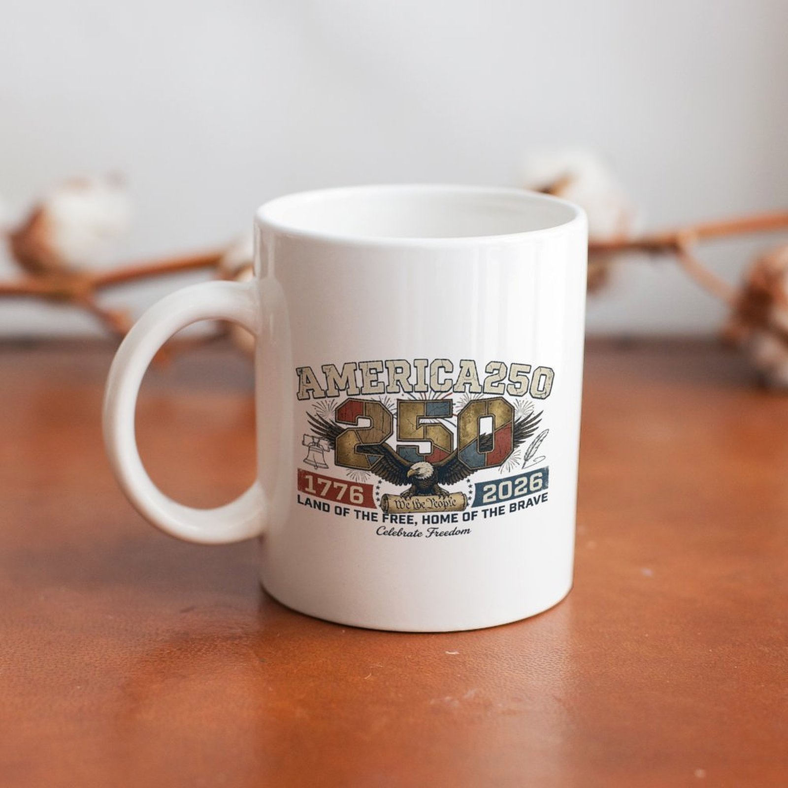 Distressed America250 eagle graphic white ceramic mug laid on rustic wooden table, vintage USA 250 anniversary farmhouse decor coffee cup