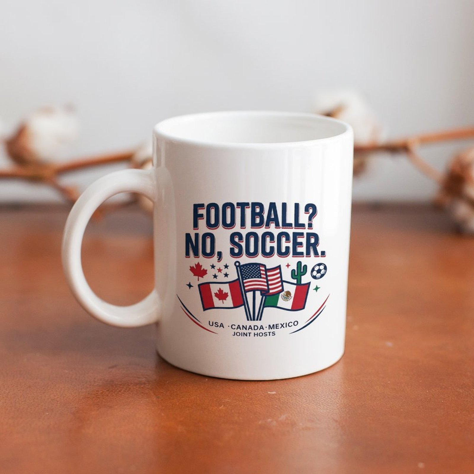 The mug displayed on a wooden table, highlighting the complete "FOOTBALL? NO, SOCCER." design.