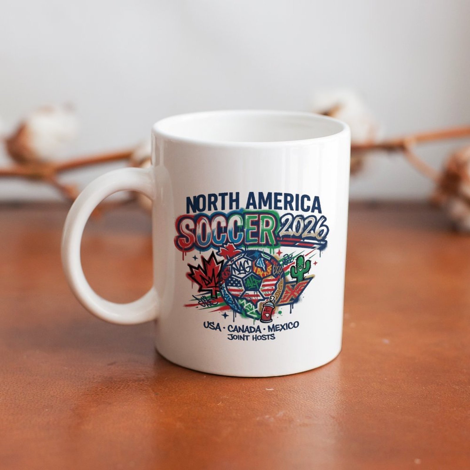 The mug displayed on a wooden table, highlighting the bold street-art soccer tournament design under soft natural light.