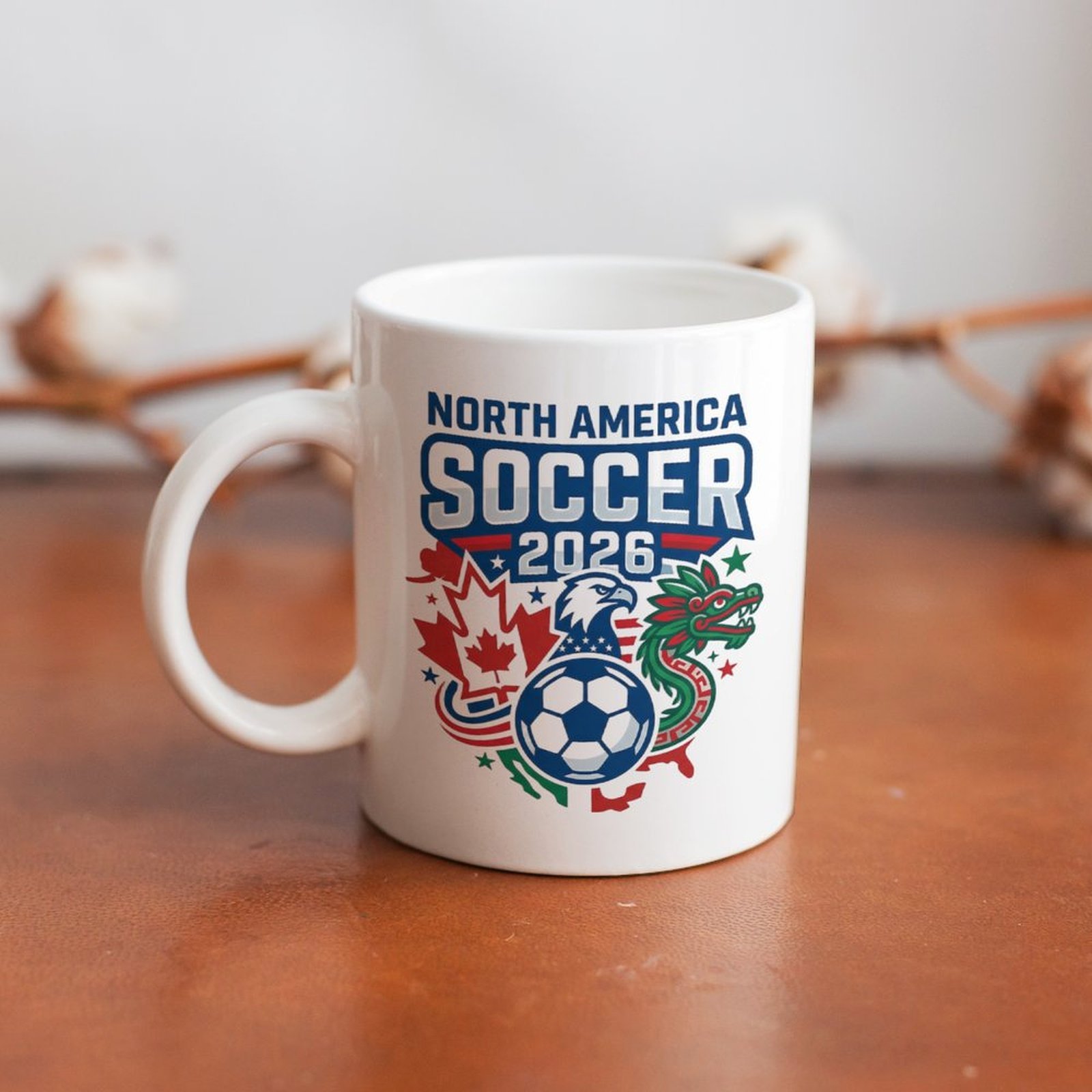 The mug displayed on a wooden table, highlighting the vibrant tournament logo design under soft natural light.