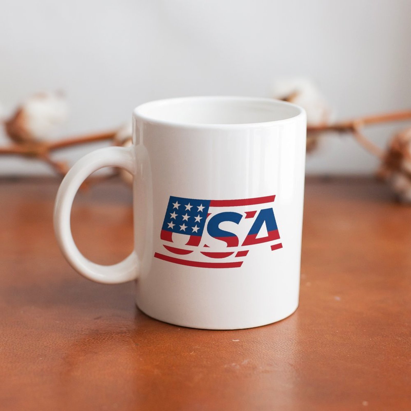 The mug displayed on a wooden table, highlighting the sleek patriotic print under soft natural light.