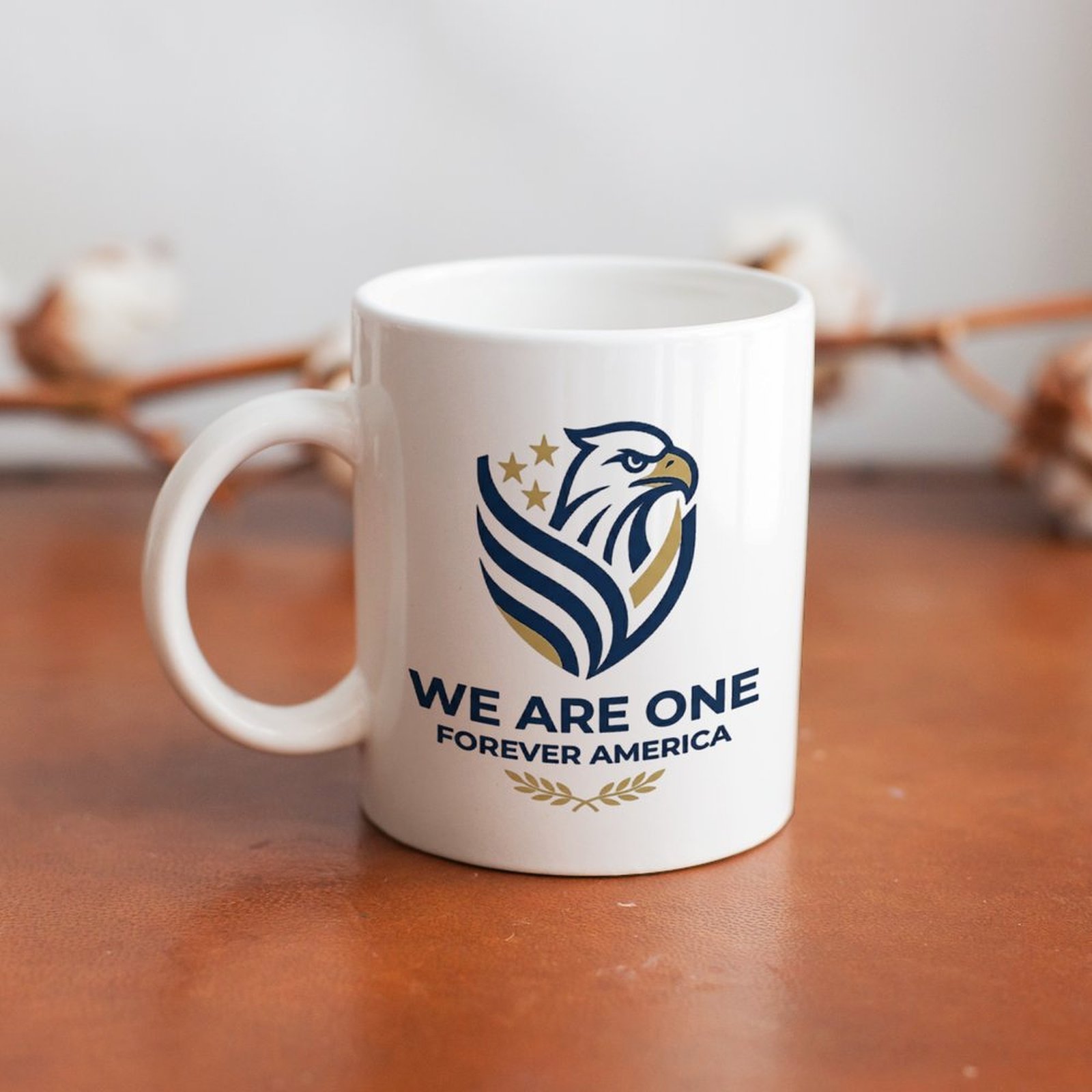 Lifestyle interior shot: patriotic eagle logo mug placed on warm wooden table with cotton sprig background for home desk decor