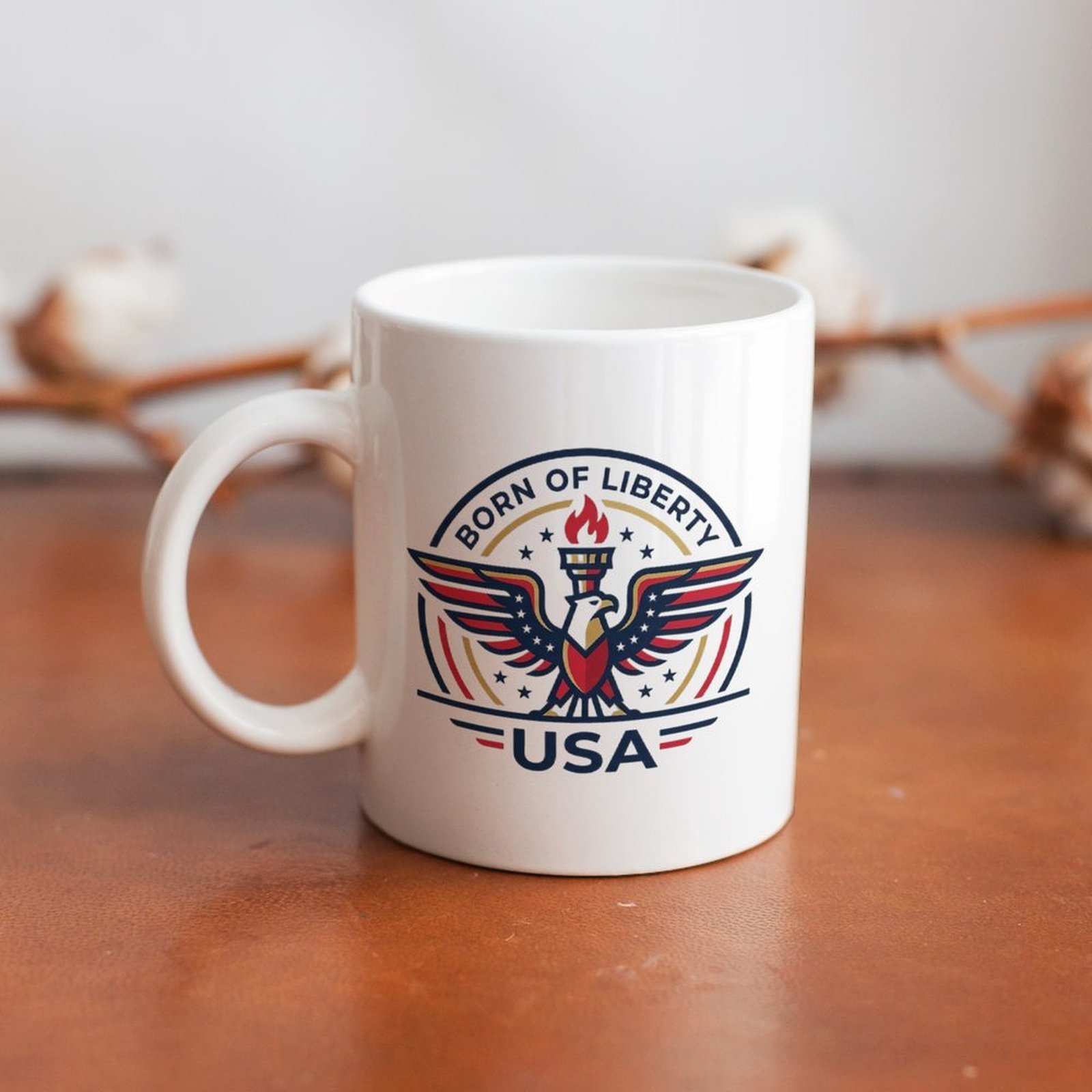 Lifestyle interior shot: patriotic eagle liberty logo mug placed on warm wooden table with cotton sprig background for home desk decor